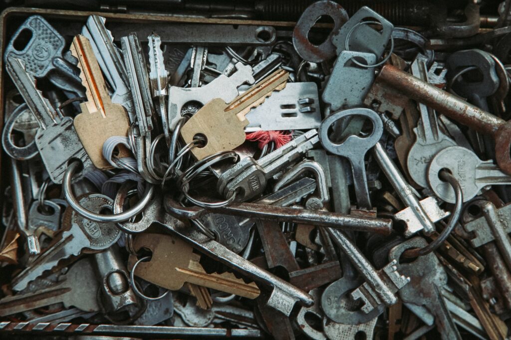 Assorted rusty metal keys piled together, showcasing a vintage and industrial feel.